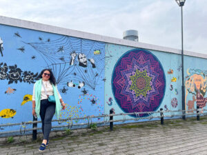 Miriam Espaillat posing in front of Murial while on their Expedition to Finland and Amsterdam with the Gambrell Foundation